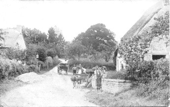 View from Peak Lane towards St Andrew’s Church and Church Lane. Lollover Thatch is the building on the right