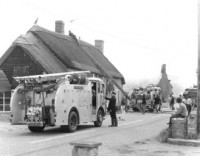 The firemen had to try to prevent the fire from spreading even further. The burning shop is the building in the background Preventing the fire from spreading to the Hare and Hounds